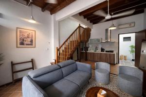 a living room with a couch and two chairs at Courtyard by Heritage Row in George Town