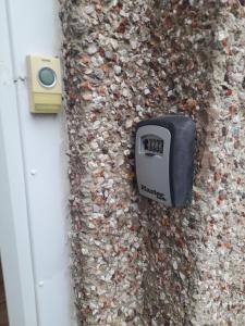 a meter on the side of a building with a rock wall at The Bolt Hole in Barmouth