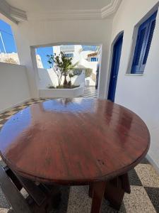 a wooden table in a room with a table at Jardins de Mezraya in Mezraya