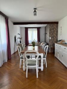 a kitchen and dining room with a table and chairs at Maison chaleureuse de village - location logement entier in Lanans +12 photos