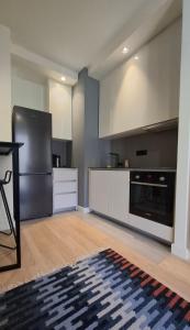 a kitchen with a black refrigerator and a stove at Belgrade Waterfront Lux Studio Apartment in Belgrade