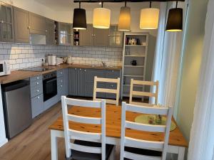 a kitchen with a wooden table and chairs at Ferienwohnung Heinrichshofen in Heinrichshofen