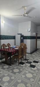 a dining room with a table and chairs at Shanti villa in Kadipur