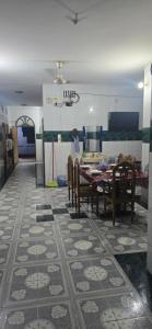 a dining room with a table and chairs in a room at Shanti villa in Kadipur