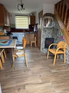 a kitchen with a table and chairs and a fireplace at Zacisze Osławy Agroturystyka in Wysoczany +16 photos
