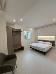 a bedroom with a bed and a chair in it at Casa Nane in Malcesine