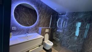 a bathroom with a sink and a toilet and a mirror at Tung Hotel in Zeewolde +30 photos