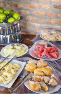 a table topped with plates of food and fruit at Hotel Bela Vista Palace in Araçariguama