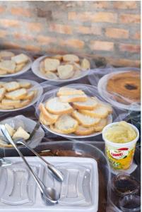 a table topped with plates of food and pies at Hotel Bela Vista Palace in Araçariguama