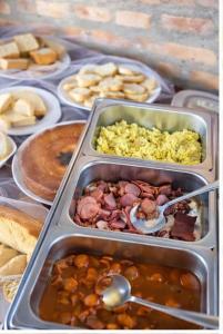 two trays of food on a table with food at Hotel Bela Vista Palace in Araçariguama +28 photos
