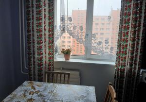 a table and a window with a view of a city at Anni Apartment in Tallinn