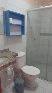 a bathroom with a toilet and a glass shower at Flat Casa Taiba 2002 in São Gonçalo do Amarante
