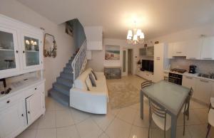 a kitchen and a living room with a staircase at B&B El Dorado in Lido di Pomposa