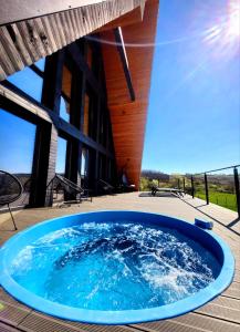 a hot tub on the deck of a house at La Salcami in Burzuc