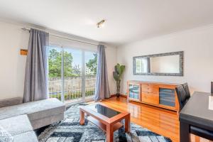 a living room with a couch and a mirror at Sardonyx Scape Madeira Close to Garajau Funchal in Caniço