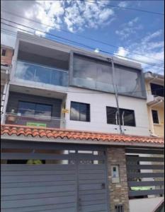 a house with a gate and a garage at Or King in Cuenca