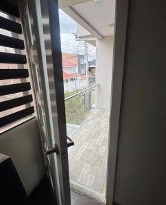 an open door with a view of a balcony at Or King in Cuenca