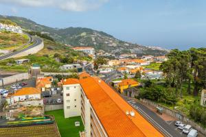 an aerial view of a city with an orange roof at Sardonyx Scape Madeira Close to Garajau Funchal in Caniço