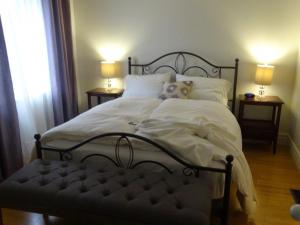 a bed with a dog sitting on top of it at villa du vignoble in Dunham