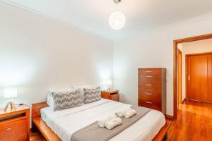 a bedroom with a bed with two towels on it at Sardonyx Scape Madeira Close to Garajau Funchal in Caniço