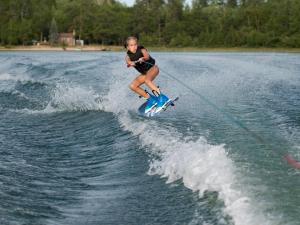 a young girl water skiing on a wave board at Lakes Small in Kaag