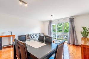 a dining room with a table and chairs at Sardonyx Scape Madeira Close to Garajau Funchal in Caniço
