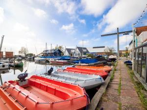 a group of boats are docked in a marina at Lakes Small in Kaag +12 photos