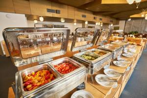 a buffet line with many trays of food at Hotel Horizont in Pec pod Sněžkou