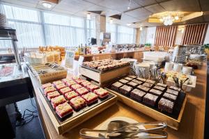 a bakery with several trays of food on display at Hotel Horizont in Pec pod Sněžkou +43 photos