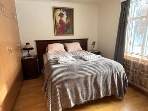 a bedroom with a bed with two towels on it at Spacious Apartment -Top Location in Akureyri