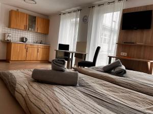 a bedroom with two beds with towels on them at Ferienhof Schäfer in Oberderdingen