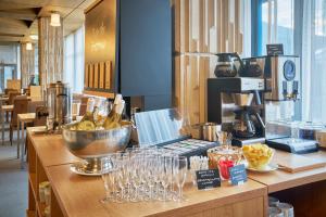 a kitchen with a counter with wine glasses on it at Hotel Horizont in Pec pod Sněžkou