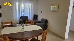 a living room with a table and a couch at Depto Diucon Centro in Esquel