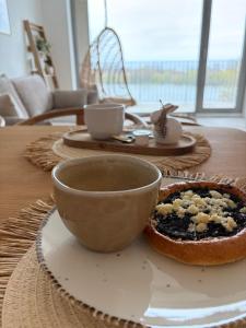 a table with a bowl and a plate of food at Bluewave boho apartment Slnava in Banka