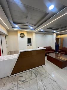 a lobby with a waiting room with a reception desk at Hotel Golden Palace in Chhatarpur +2 photos