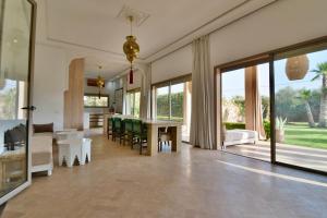 a large living room with a table and chairs at Dar Sofia Villa in Marrakesh