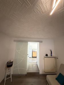 a living room with a coffered ceiling and a hallway at La Parenthèse coté Saar in Wittring