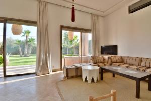 a living room with a couch and a table at Dar Sofia Villa in Marrakesh