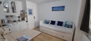 a living room with a couch and a table at Sète Centre ville T2 rénové in Sète