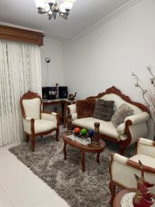 a living room with a couch and two chairs and a table at Casa Roldanillo in Roldanillo