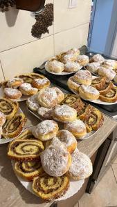 a bunch of pastries on plates on a table at Pensiunea Maramu in Breb