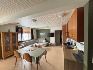 a living room with a table and a couch at Varpholt House Apartments & Rooms in Akureyri