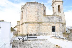 an old church with a table and chairs on the roof at Campanile Inn in Locorotondo