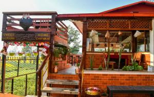 a small house with a porch and a home china store at Sweet Home in Chitwan