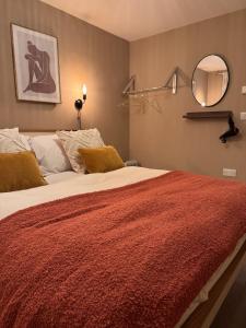 a bedroom with a large bed with a red blanket at The Lazy Fox, Shrewsbury in Shrewsbury