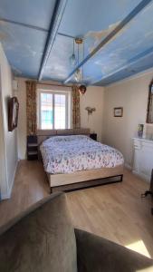 a bedroom with a large bed in a room at Chez Laurence in Locronan
