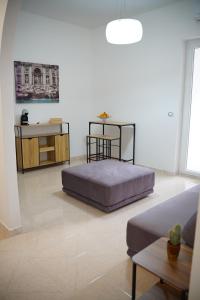 a bedroom with a bed and a table and a couch at Giocca Rooms in Palagiano +19 photos