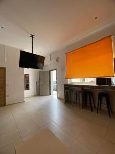 a dining room with a table and a large window at Corinth Beach Apartment and Hostel in Korinthos