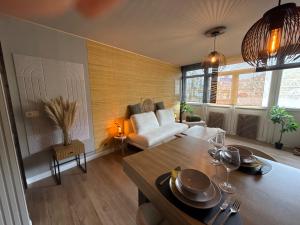 a living room with a couch and a table at Capstay Dinant in Dinant