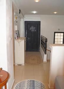 a hallway with a black door in a house at Duplex T3 résidence Djnen el Bey in Annaba
